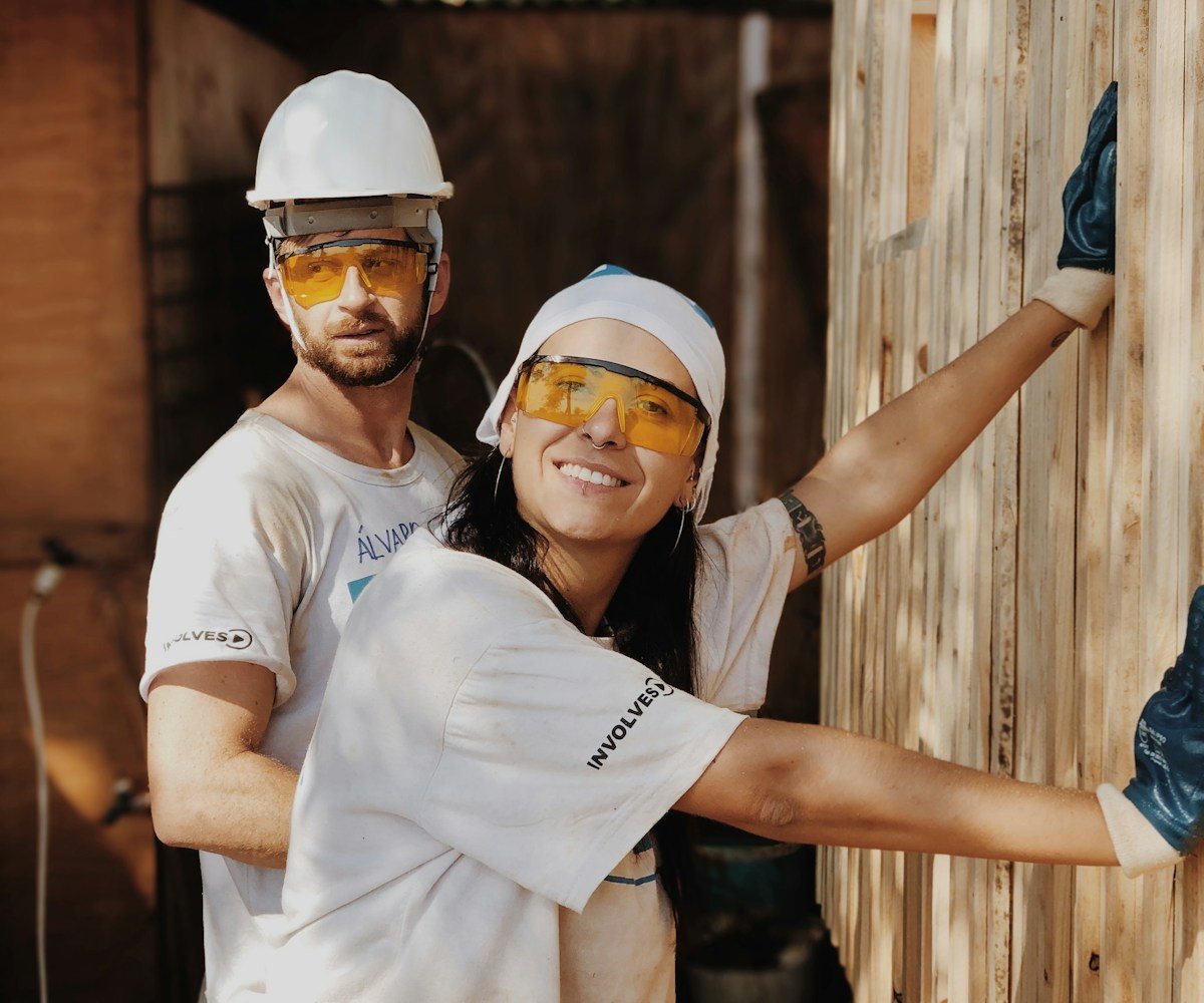 Construction crew member in a hard hat and safety glasses on a job site
